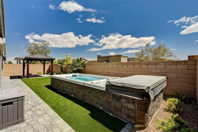 view of pool featuring a gazebo, a fenced backyard, a patio, and an outdoor hot tub