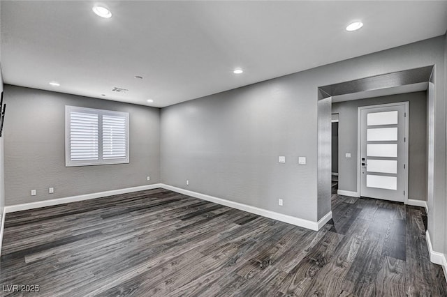 unfurnished room with visible vents, recessed lighting, and wood finished floors