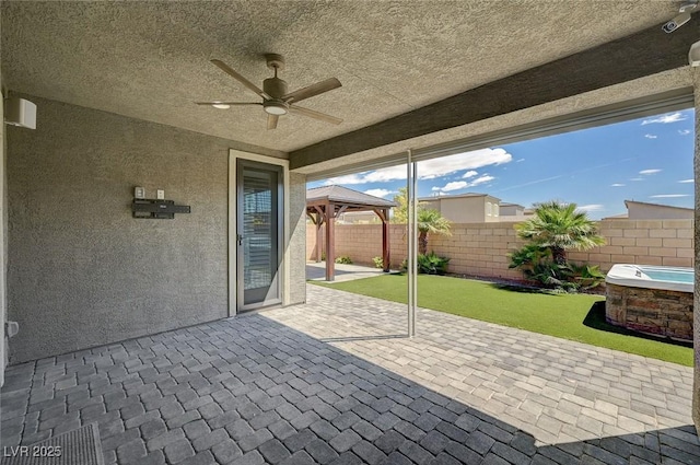 view of patio with a gazebo, a ceiling fan, and a fenced backyard