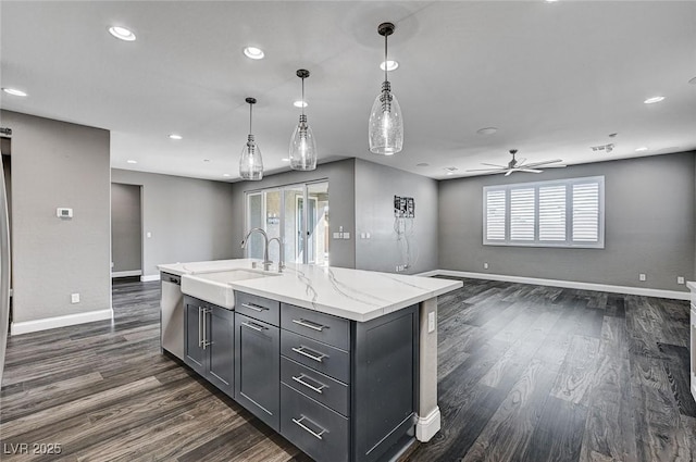 kitchen featuring baseboards, open floor plan, a sink, dark wood finished floors, and dishwasher