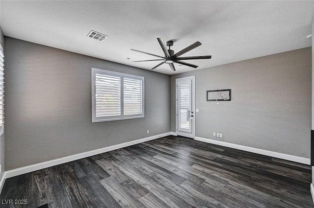 unfurnished room with dark wood-style flooring, a ceiling fan, visible vents, and a healthy amount of sunlight