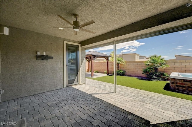 view of patio / terrace featuring a gazebo, a fenced backyard, and ceiling fan