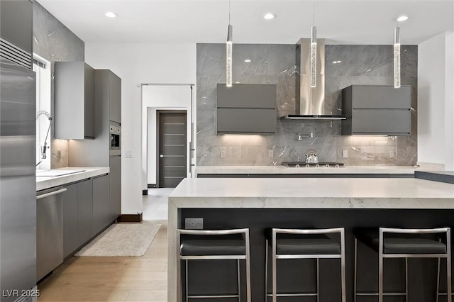 kitchen with light countertops, gray cabinets, modern cabinets, and stainless steel appliances