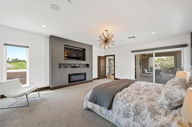 carpeted bedroom with visible vents, a glass covered fireplace, access to exterior, baseboards, and a notable chandelier