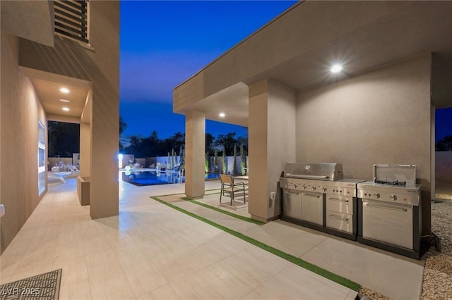 patio at twilight featuring a fenced in pool and exterior kitchen