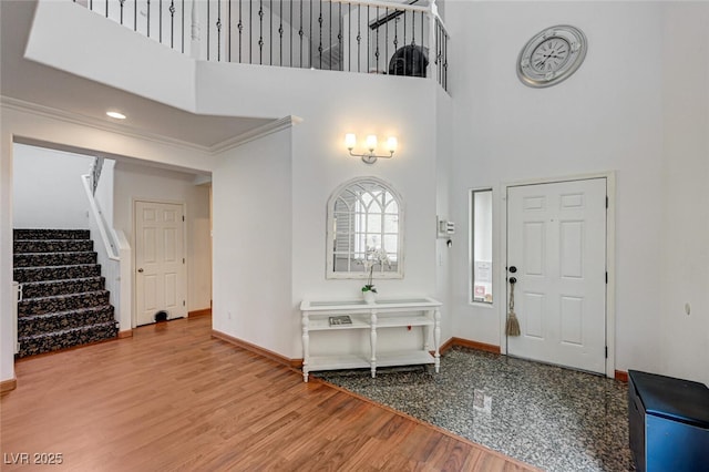 10519 Bella Camrosa Dr, Las Vegas, NV 89141 - entrance foyer featuring crown molding, wood finished floors, baseboards, a high ceiling, and stairway