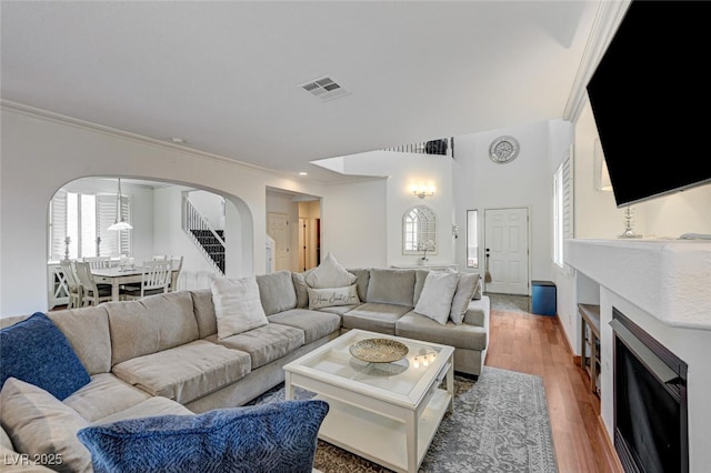 10519 Bella Camrosa Dr, Las Vegas, NV 89141 - living area with crown molding, arched walkways, a healthy amount of sunlight, and visible vents