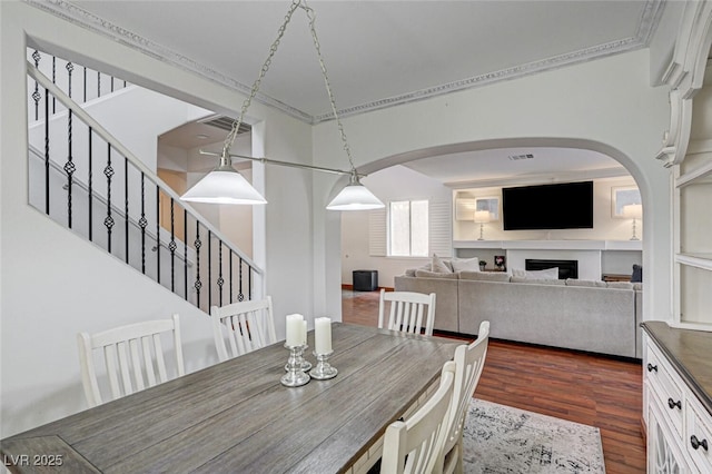 10519 Bella Camrosa Dr, Las Vegas, NV 89141 - dining room featuring arched walkways, stairs, and dark wood-style floors