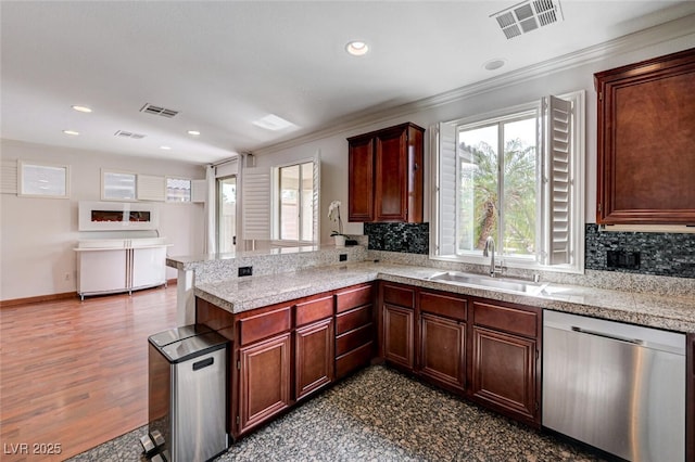 10519 Bella Camrosa Dr, Las Vegas, NV 89141 - kitchen with crown molding, a sink, a peninsula, stainless steel dishwasher, and visible vents