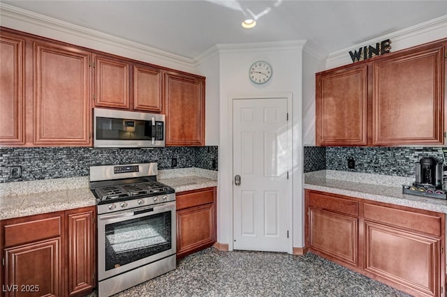 10519 Bella Camrosa Dr, Las Vegas, NV 89141 - kitchen featuring crown molding, brown cabinetry, appliances with stainless steel finishes, and tasteful backsplash