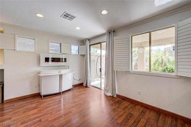 10519 Bella Camrosa Dr, Las Vegas, NV 89141 - empty room with visible vents, ornamental molding, baseboards, and wood finished floors