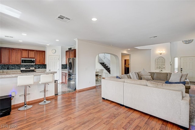 10519 Bella Camrosa Dr, Las Vegas, NV 89141 - living area featuring recessed lighting, arched walkways, light wood finished floors, and visible vents