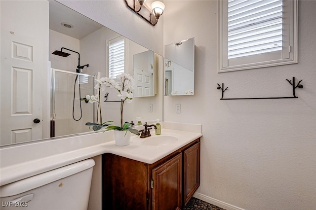 10519 Bella Camrosa Dr, Las Vegas, NV 89141 - bathroom featuring vanity, baseboards, a shower with shower door, and toilet
