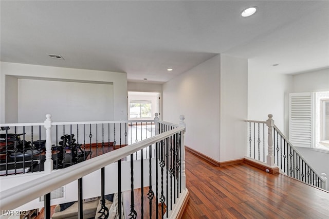 10519 Bella Camrosa Dr, Las Vegas, NV 89141 - hallway with visible vents, wood finished floors, baseboards, recessed lighting, and an upstairs landing