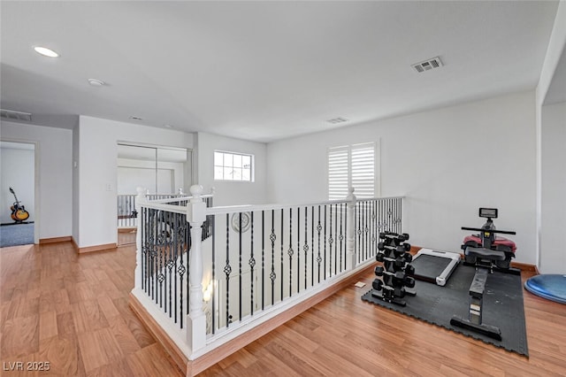 10519 Bella Camrosa Dr, Las Vegas, NV 89141 - exercise area with baseboards, wood finished floors, and visible vents
