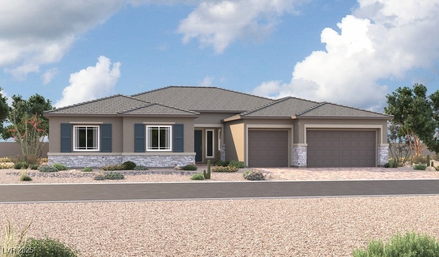 prairie-style house with decorative driveway, an attached garage, stone siding, and stucco siding
