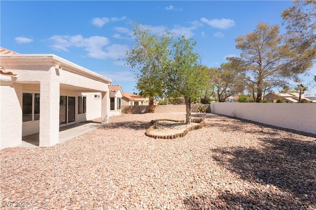 view of yard with a fenced backyard and a patio