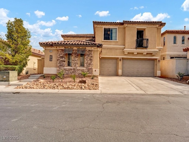 mediterranean / spanish house featuring concrete driveway, an attached garage, a balcony, and stucco siding