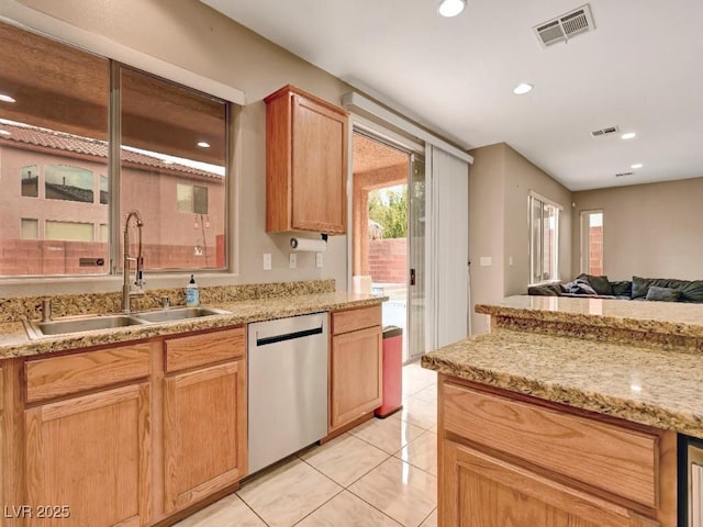 kitchen featuring a sink, stainless steel dishwasher, light tile patterned flooring, and visible vents