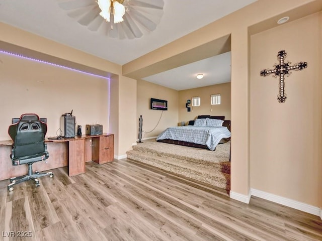 bedroom featuring baseboards and wood finished floors