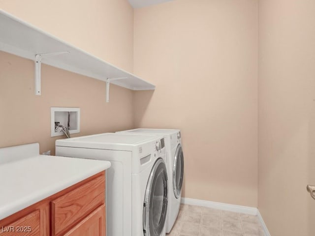 washroom featuring baseboards, cabinet space, and washing machine and clothes dryer