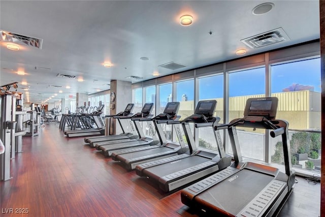 exercise room featuring visible vents and wood finished floors