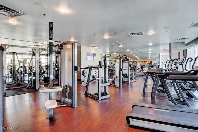 workout area featuring visible vents and wood finished floors