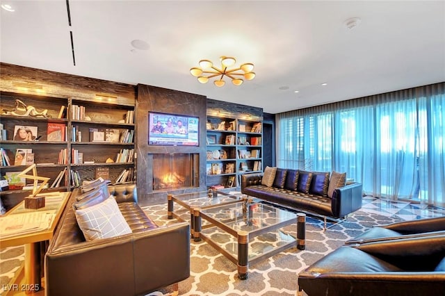 living room featuring a large fireplace and built in shelves