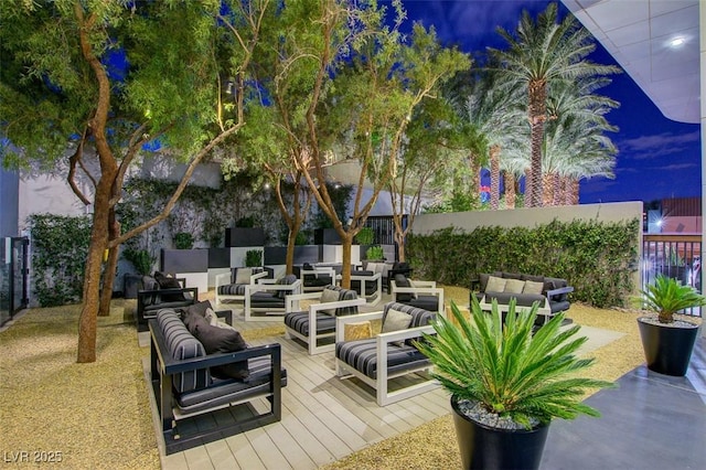 view of patio / terrace featuring fence, outdoor lounge area, and a wooden deck