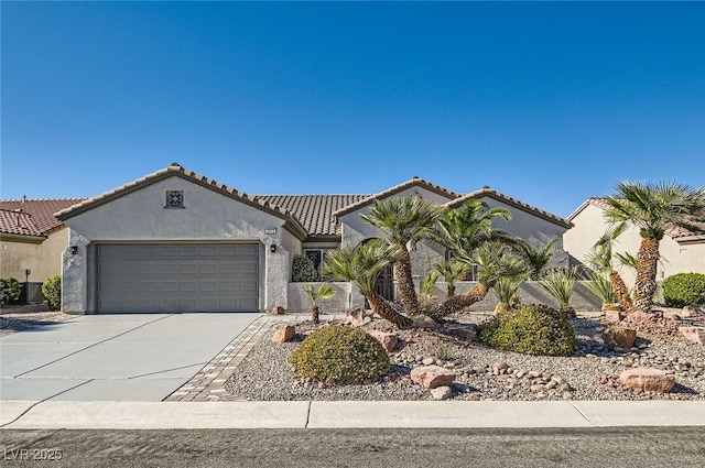 2372 Perrysburg Dr, Henderson, NV 89044 - mediterranean / spanish-style house featuring an attached garage, concrete driveway, stucco siding, and a tiled roof