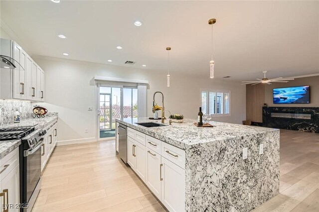2372 Perrysburg Dr, Henderson, NV 89044 - kitchen featuring stainless steel appliances, a sink, plenty of natural light, light stone countertops, and recessed lighting