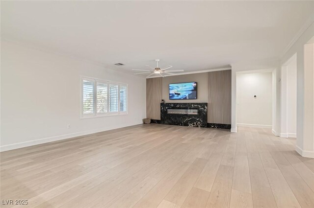 2372 Perrysburg Dr, Henderson, NV 89044 - unfurnished living room with light wood-style flooring, a ceiling fan, baseboards, and ornamental molding