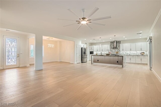 2372 Perrysburg Dr, Henderson, NV 89044 - unfurnished living room with a chandelier, ceiling fan, light wood finished floors, baseboards, and recessed lighting