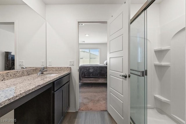 13 Deseo Ct, North Las Vegas, NV 89031 - ensuite bathroom featuring wood finished floors, ensuite bathroom, a stall shower, and vanity