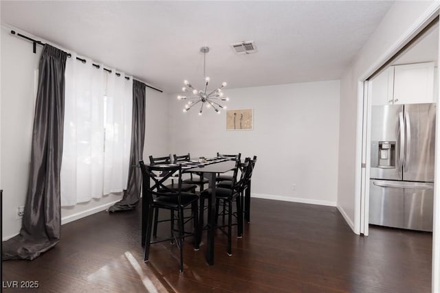 dining area featuring visible vents, dark wood-style flooring, baseboards, and a chandelier