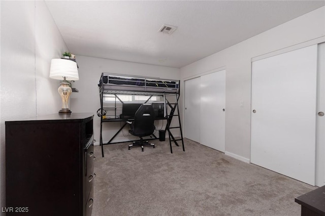 carpeted bedroom featuring two closets and visible vents