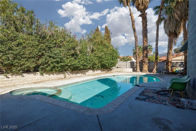 view of swimming pool with a patio, a fenced backyard, and a pool with connected hot tub