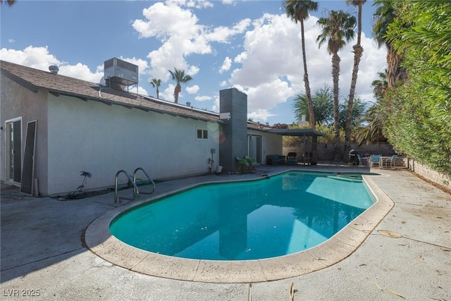 view of swimming pool featuring central air condition unit, fence, a fenced in pool, and a patio area