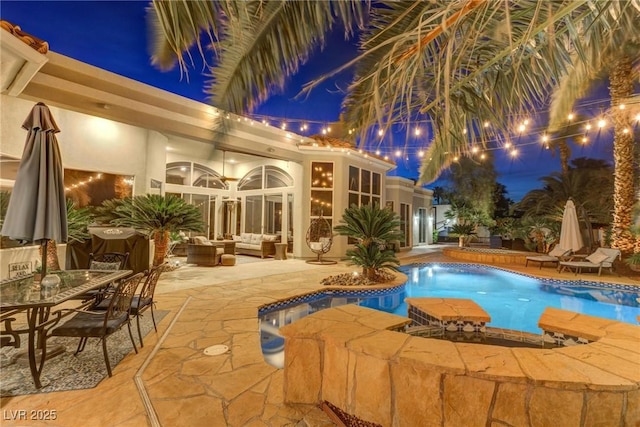 4594 Blue Mesa Way, Las Vegas, NV 89129 - pool at twilight with a patio area, an outdoor pool, an outdoor hangout area, and outdoor dining space