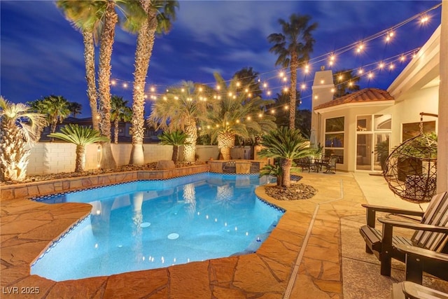 4594 Blue Mesa Way, Las Vegas, NV 89129 - pool at night with a fenced in pool, a fenced backyard, and a patio