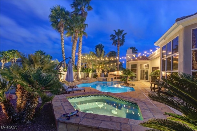 4594 Blue Mesa Way, Las Vegas, NV 89129 - pool at night featuring an in ground hot tub, a patio area, and an outdoor pool