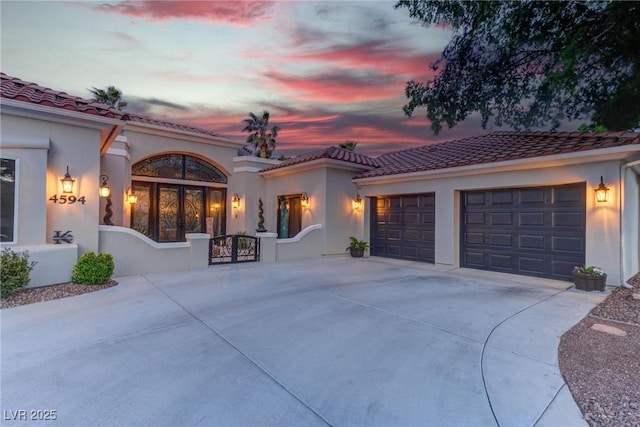 4594 Blue Mesa Way, Las Vegas, NV 89129 - exterior space with a garage, stucco siding, driveway, and a tile roof