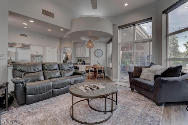 4594 Blue Mesa Way, Las Vegas, NV 89129 - living area featuring a high ceiling, light wood-style floors, arched walkways, recessed lighting, and visible vents