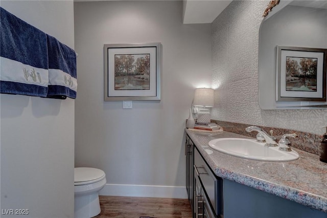 4594 Blue Mesa Way, Las Vegas, NV 89129 - bathroom with vanity, baseboards, wood finished floors, and toilet