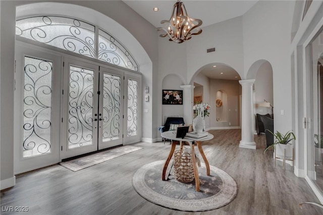 4594 Blue Mesa Way, Las Vegas, NV 89129 - entryway featuring decorative columns, visible vents, arched walkways, wood finished floors, and a high ceiling