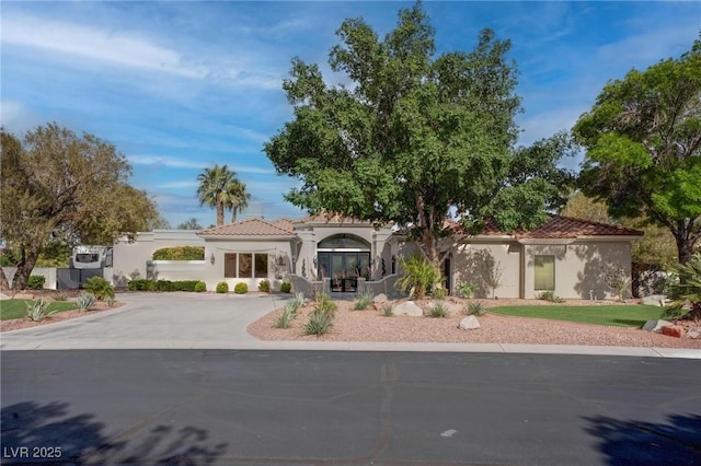 4594 Blue Mesa Way, Las Vegas, NV 89129 - mediterranean / spanish-style home featuring curved driveway, stucco siding, and a tile roof