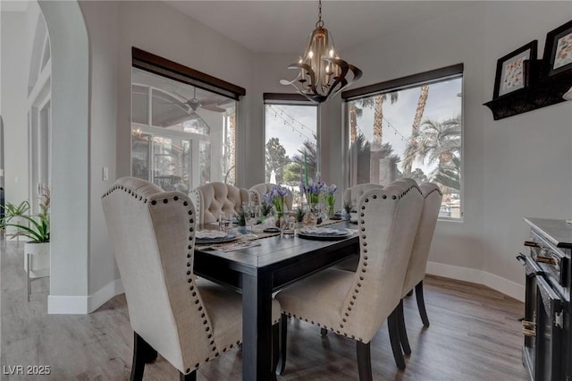4594 Blue Mesa Way, Las Vegas, NV 89129 - dining space with baseboards, a chandelier, a wealth of natural light, and wood finished floors