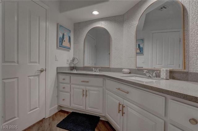 4594 Blue Mesa Way, Las Vegas, NV 89129 - bathroom featuring double vanity, visible vents, a sink, and wood finished floors