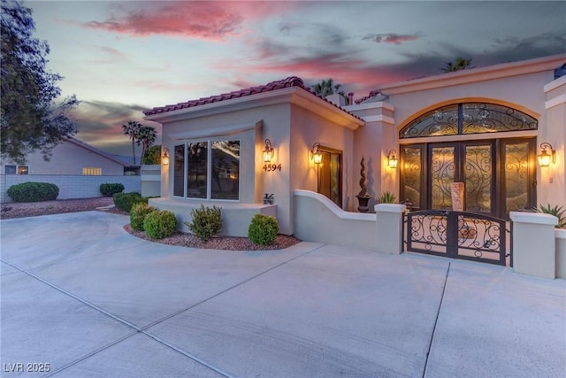 4594 Blue Mesa Way, Las Vegas, NV 89129 - entrance to property featuring fence, a gate, stucco siding, and a tiled roof