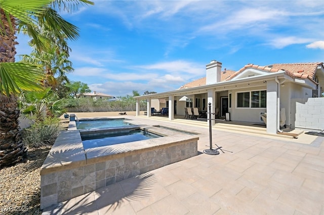 view of swimming pool featuring a patio, an in ground hot tub, fence, and a fenced in pool